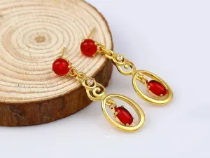 Fashionable long earrings with red ruby stones