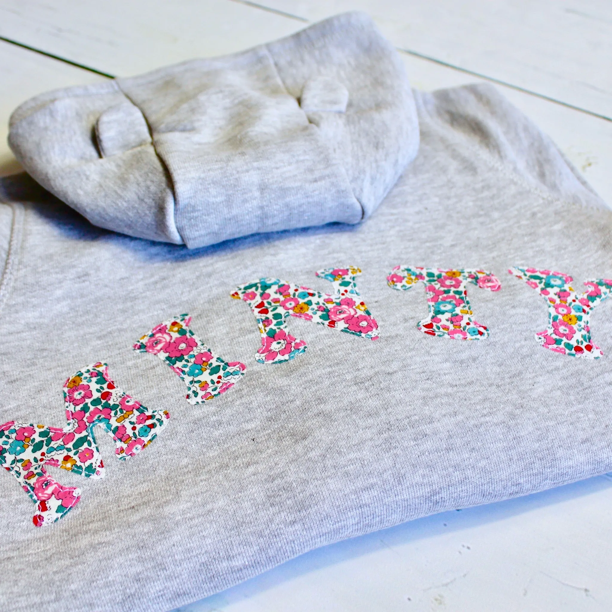 Name onesie with knee patches
