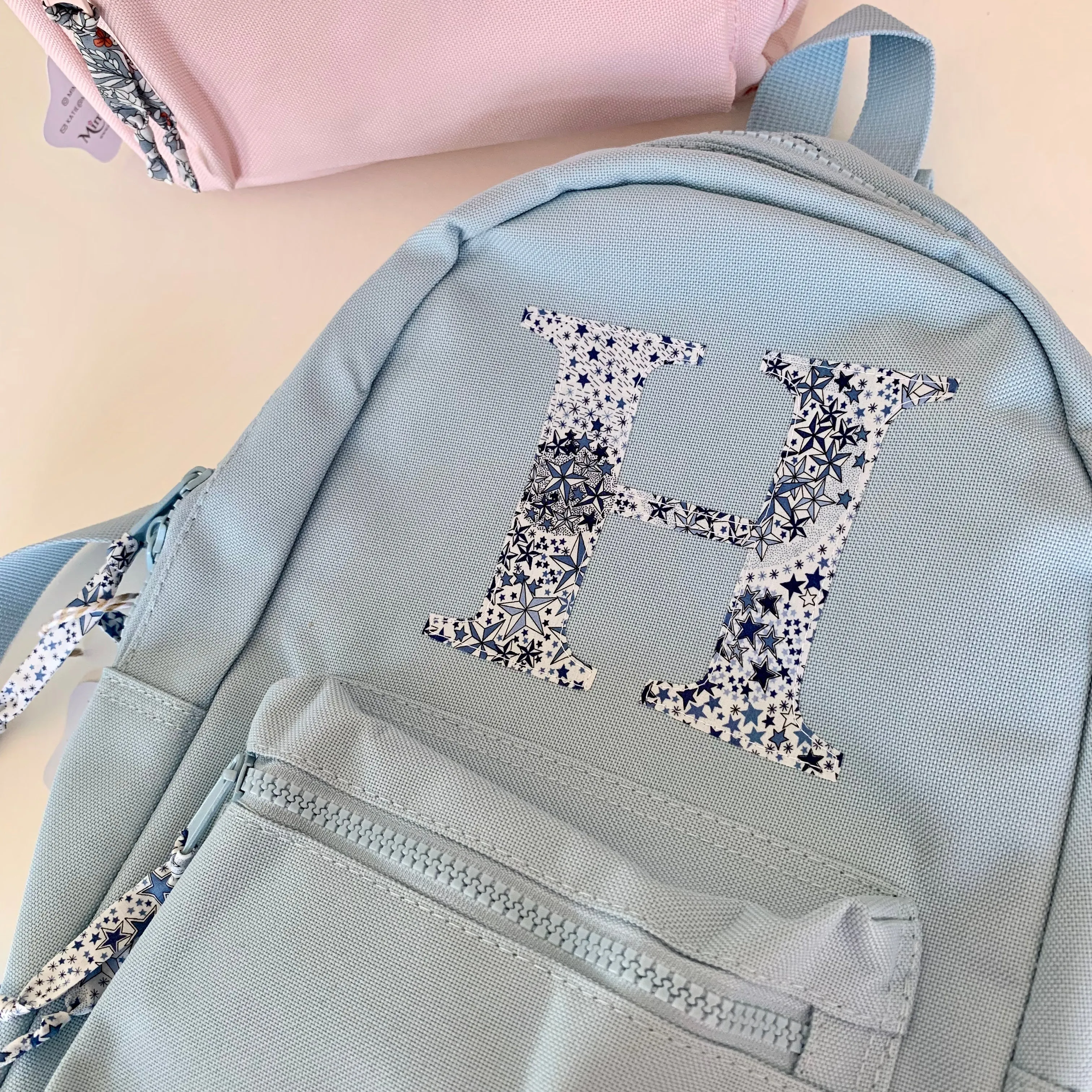 Pale blue initial backpack